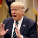 President Trump shows everyone how he would eat a gigantic apple while meeting with members of several veterans service organizations on March 17, 2017 (Photo by Chip Somodevilla/Getty Images)